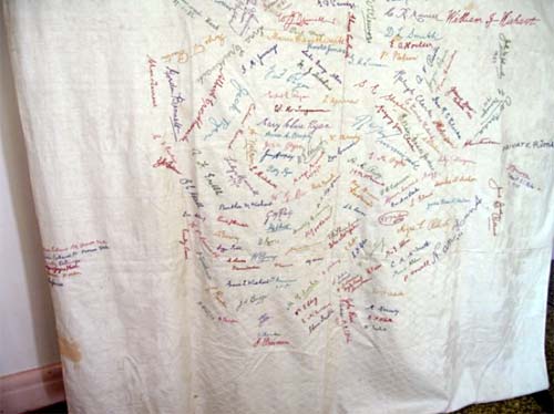table cloth with embroidered signatures of townsfolk